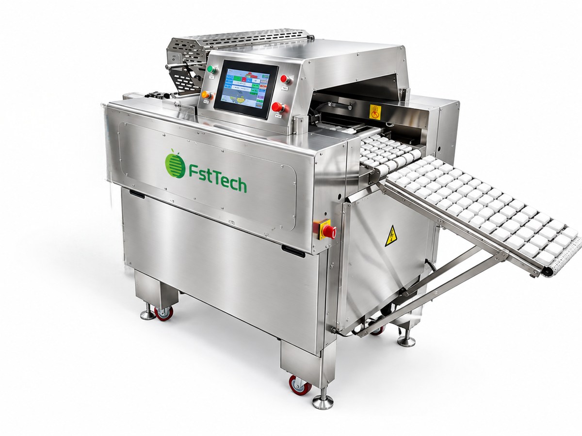 Cling film wrapping machine sealing trays of produce on the vegetable packing line